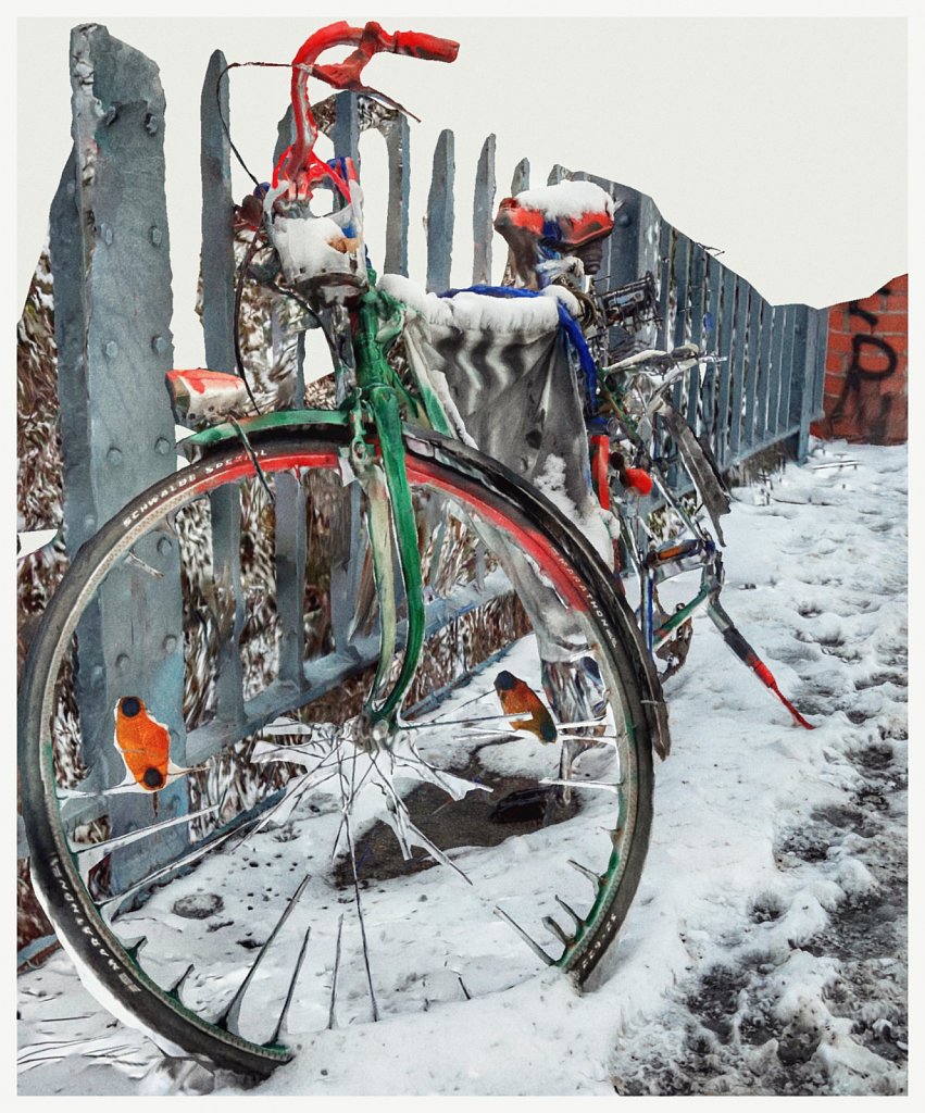 a bicycle parked next to a fence in the snow